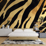 Black and gold tiger print wallpaper creating drama in a modern living room with contemporary furniture