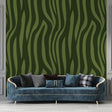 Modern green zebra print wallpaper mural displayed in a bright contemporary living room with minimal furniture