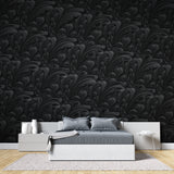Black Baroque wallpaper creating drama in a modern living room with leather furniture