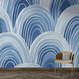 Modern Art Deco blue arch wallpaper in a bright living room with mid-century furniture and natural light