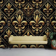 Black and gold Art Deco wallpaper in modern living room setting, showing Fleur de Lis pattern catching evening light