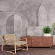 Modern Art Deco geometric wallpaper with arches and circles creating depth in a minimalist living room setting
