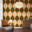 Art deco fan pattern wallpaper in gold and black creating drama in a modern dining room with crystal chandelier