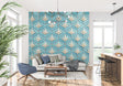 Art deco geometric wallpaper in modern living room with grey sofa and brass accents