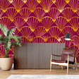 Art Deco fan pattern wallpaper in burgundy and gold creating drama in a modern dining room