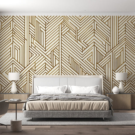 Gold geometric Art Deco wallpaper creating drama in a modern living room with high ceilings and minimal furniture
