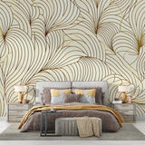 Art deco feather wallpaper in gold and beige creates a stunning backdrop in an elegant dining room with modern furniture