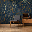 Art deco gold wave wallpaper in modern dining room with crystal chandelier and navy accents
