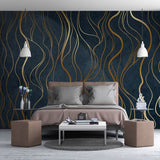 Navy and gold wave wallpaper in home office with modern furniture and warm lighting