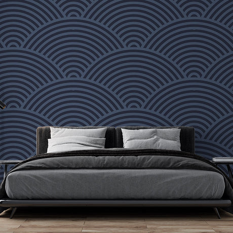 Navy blue art deco wave wallpaper creating depth in a modern dining room with ambient lighting