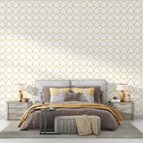 Art deco scale pattern wallpaper in white and gold creating a luxurious atmosphere in a modern living room
