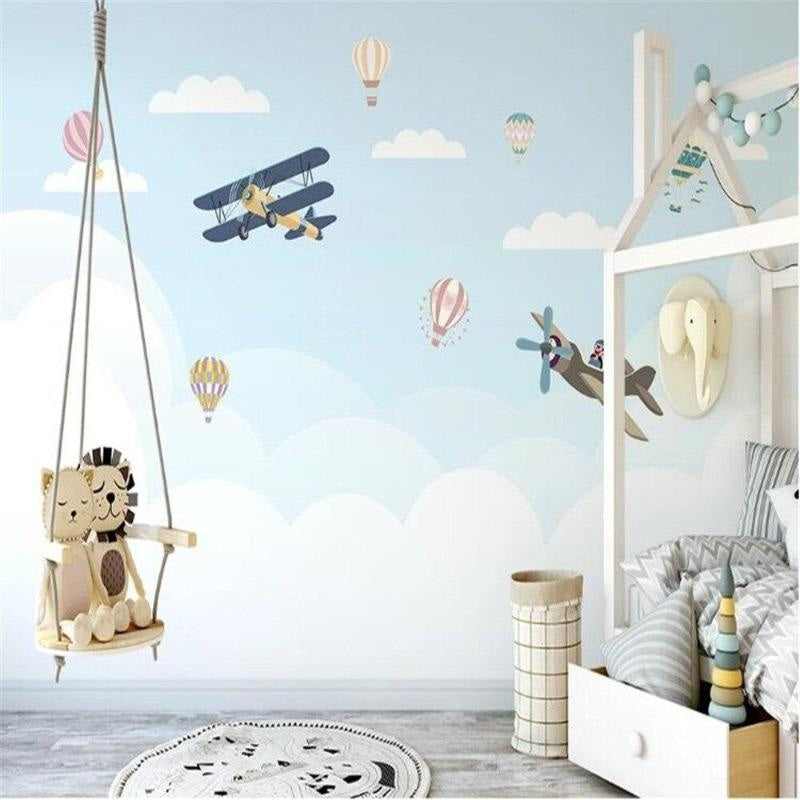 Aviation wallpaper mural bringing adventure to a bright nursery with hot air balloons and vintage planes