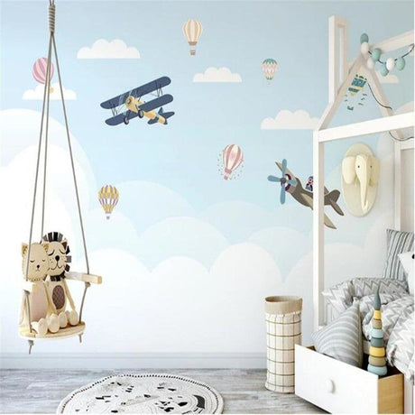 Aviation wallpaper mural bringing adventure to a bright nursery with hot air balloons and vintage planes