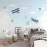 Playroom featuring aviation themed wallpaper with floating hot air balloons and biplanes