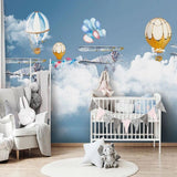 Kids bedroom featuring airplane and hot air balloon wallpaper, showing playful sky design