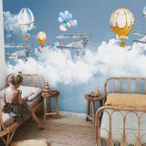 Study space decorated with aviation themed wallpaper showing floating balloons and planes