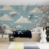 Hot air balloon wallpaper creating a dreamy atmosphere in a bright nursery with soft pink and blue tones