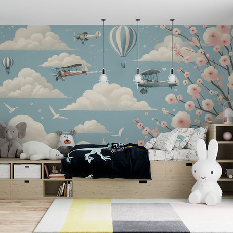 Hot air balloon wallpaper creating a dreamy atmosphere in a bright nursery with soft pink and blue tones