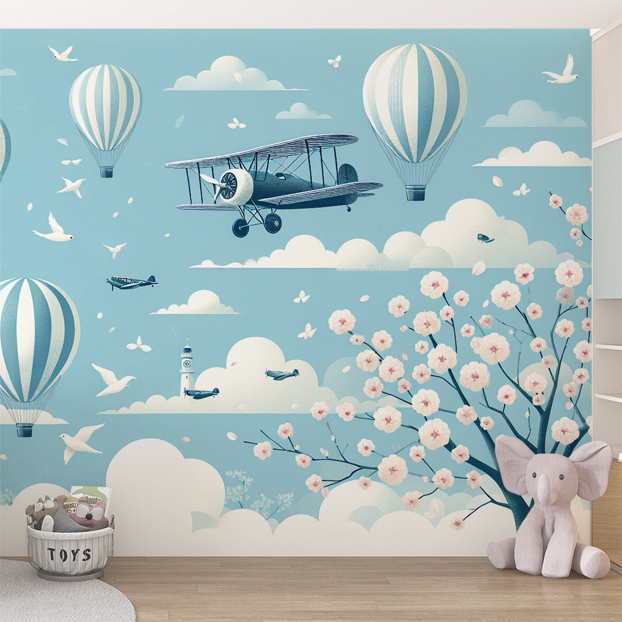 Hot air balloon wallpaper with cherry blossoms creating a magical atmosphere in a bright nursery with white furniture