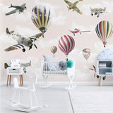 Aviation wallpaper mural styled in modern nursery with vintage planes and hot air balloons creating a dreamy atmosphere