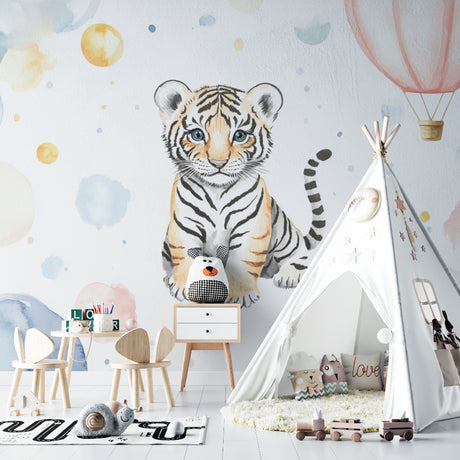 Baby tiger wallpaper in a bright nursery with white furniture, showing the watercolor design's soft glow