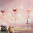 Ballet dancer wallpaper creating a magical atmosphere in a little girl's bedroom with soft pink lighting