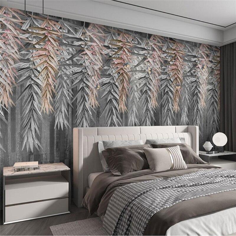 Rose gold bamboo leaf wallpaper creating a luxurious atmosphere in a modern living room with gray furniture