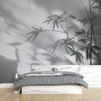 Bamboo shadow wallpaper creating a serene atmosphere in a modern minimalist living room with natural light