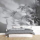 Bamboo shadow wallpaper creating a serene atmosphere in a modern minimalist living room with natural light