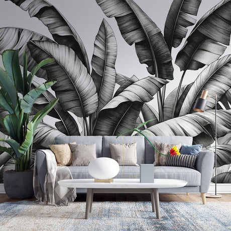 Black and white botanical wallpaper creating drama in a modern living room with clean lines and natural light