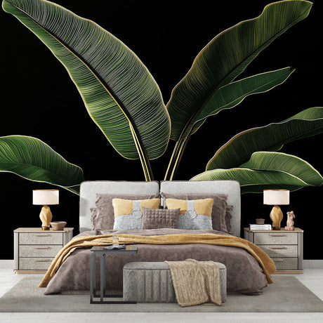 Tropical banana leaf wallpaper creating dramatic impact in a modern living room with black accent wall and gold accessories