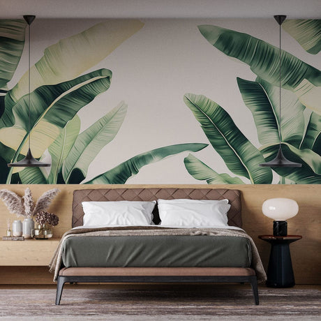 Banana leaf wallpaper creating a fresh tropical feel in a modern living room with white furniture and natural light