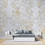 Gold damask wallpaper bringing luxury to entrance hallway with chandelier