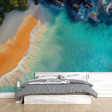 Coastal paradise beach wallpaper creating a bright, airy atmosphere in a modern living room with white furniture