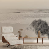 Black and white beach wallpaper creating a serene focal point in a modern living room with minimal furniture