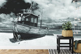 Beach wall mural creating peaceful atmosphere in modern living room with monochrome fishing boat design