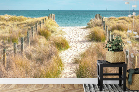 Beach path wallpaper creating a coastal feel in a bright modern living room with white furniture