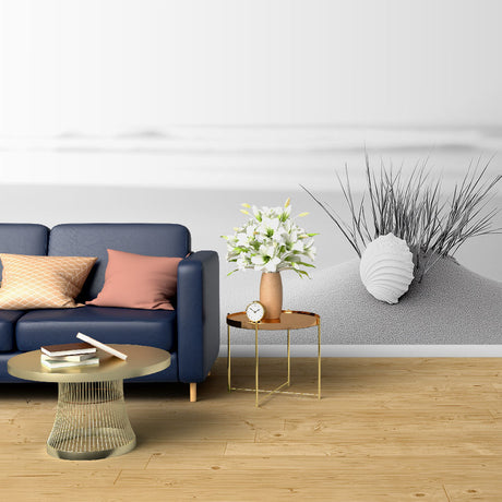 Black and white beach scene wallpaper creating a calm atmosphere in a modern living room with minimal furniture