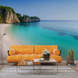 Beach mural wallpaper creating a stunning focal point in a modern living room with natural light highlighting the turquoise waters