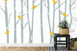Birch forest wallpaper with yellow birds in a bright Scandinavian living room setting