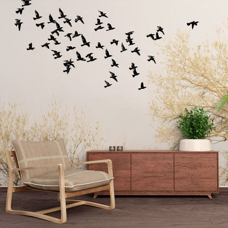 Birds Mural Wallpaper creating movement and depth in a modern living room, black silhouettes with golden trees on white background