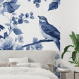 Blue bird wallpaper mural in bright modern living room showing watercolor floral design
