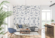 Blue Toile de Jouy bird wallpaper in a bright dining room with white wainscoting and crystal chandelier
