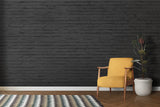 Industrial brick mural in loft-style kitchen with stainless steel appliances