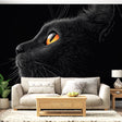 Black cat wall mural creates dramatic impact in modern living room, amber eyes catching light against dark walls
