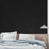 Leather effect wallpaper adding drama to master bedroom