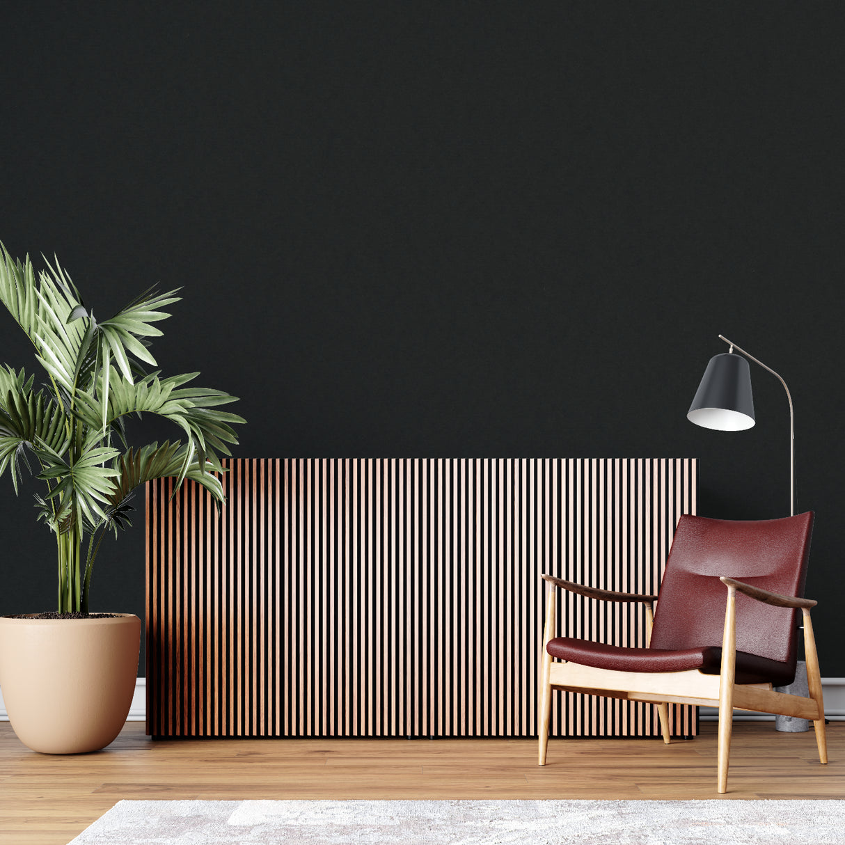 Home office with black matte accent wall showcasing art pieces