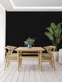 Modern Black Mural Wallpaper creating depth in a minimalist living room with natural light