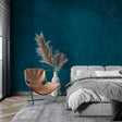 Teal textured wallpaper in modern living room with natural light highlighting surface details