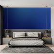 Modern blue and gold wave wallpaper in a bright living room with contemporary furniture